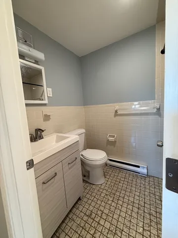 a bathroom with a sink a toilet and a mirror