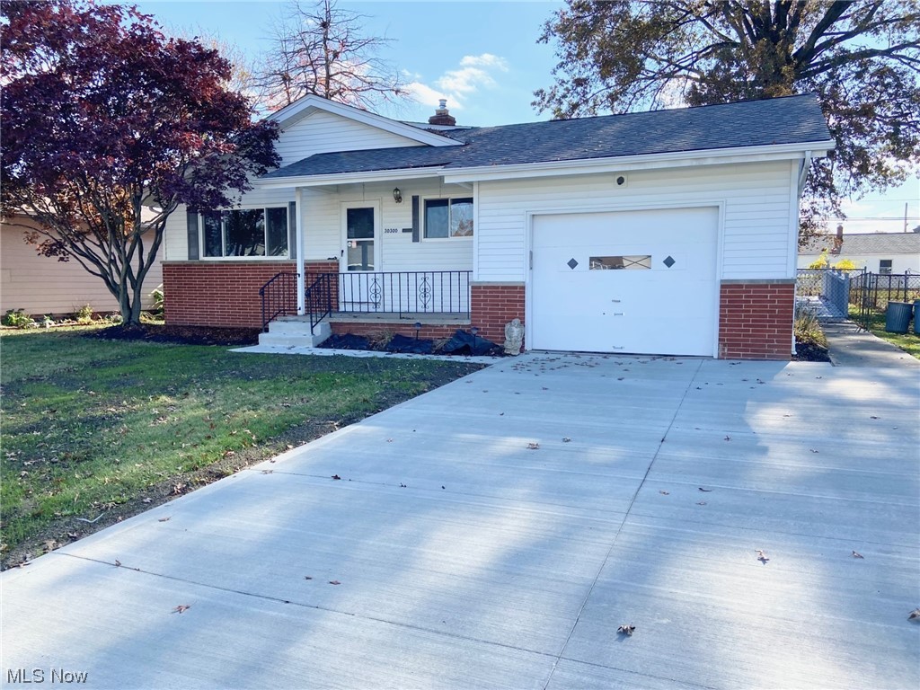 30300 Vineyard Road Willowick, OH 44095 - Photo 1 of 17 View of front facade featuring a front porch and a garage with 2023 Driveway replacement.