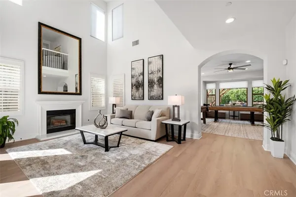 a living room with furniture a large window and a fireplace