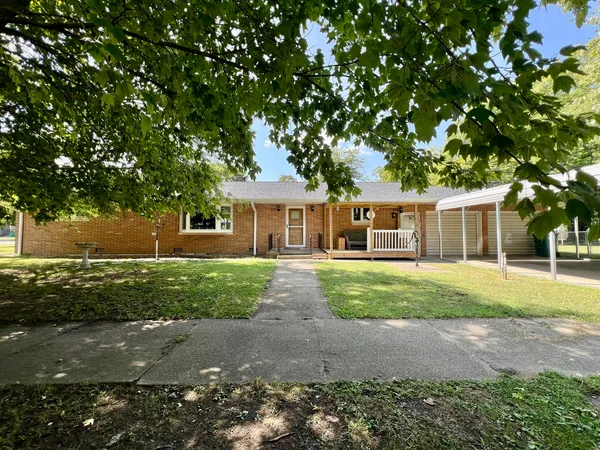a front view of a house with a yard and a garage