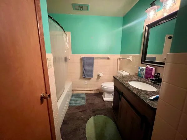 a bathroom with a sink toilet and mirror