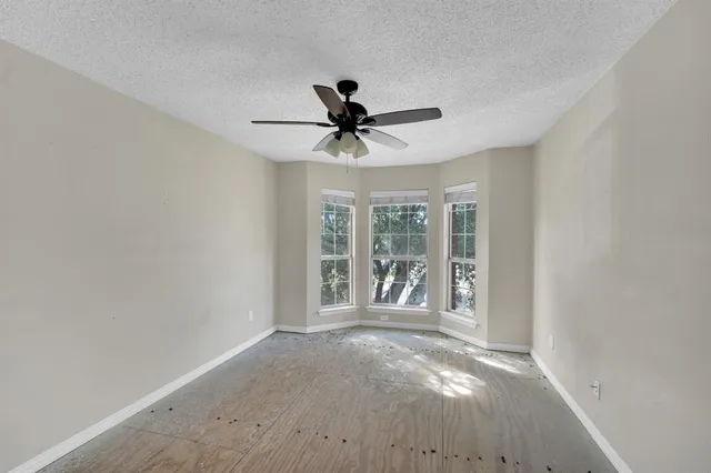 a view of a livingroom with a ceiling fan and window