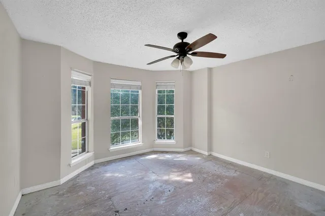 a view of a livingroom with a ceiling fan and window