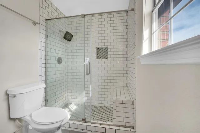 a bathroom with a toilet and shower
