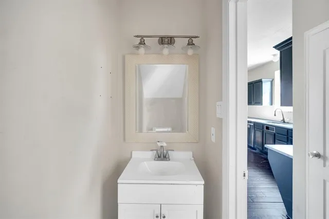 a bathroom with a sink and mirror