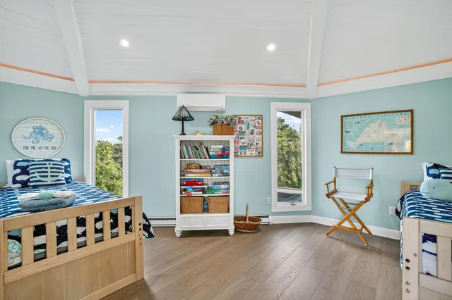 a bedroom with furniture and a wooden floor