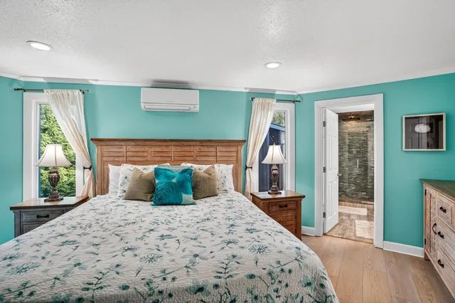 a bedroom with a large bed and a large window