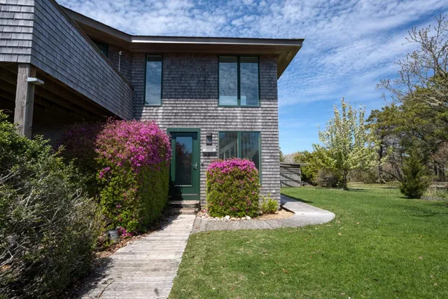 a front view of a house with a garden