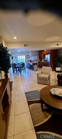 a living room with furniture and a kitchen view