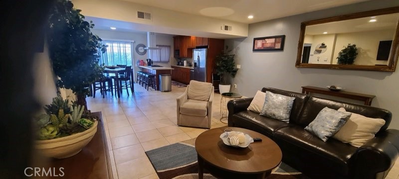 1851 Glenoaks Avenue, Unit C Anaheim, CA 92801 - Photo 16 of 21 a living room with furniture and wooden floor