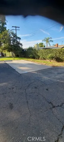 a view of hallway with a chair and a door