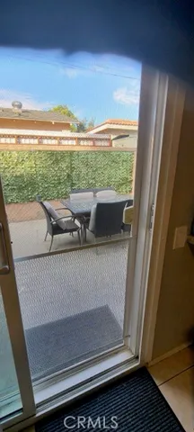 a dining room with stainless steel appliances kitchen island granite countertop a table chairs and a refrigerator