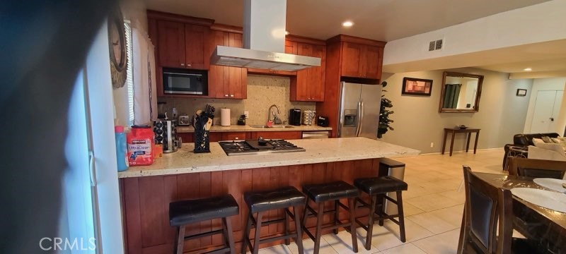 1851 Glenoaks Avenue, Unit C Anaheim, CA 92801 - Photo 21 of 21 a dining room with stainless steel appliances kitchen island granite countertop a table chairs and a refrigerator