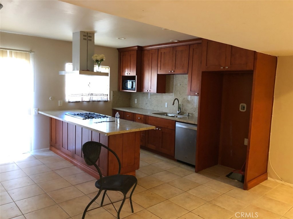 1851 Glenoaks Avenue, Unit C Anaheim, CA 92801 - Photo 5 of 21 a kitchen with granite countertop a sink cabinets and stainless steel appliances