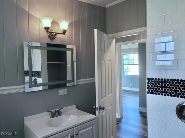 a bathroom with a sink and a mirror