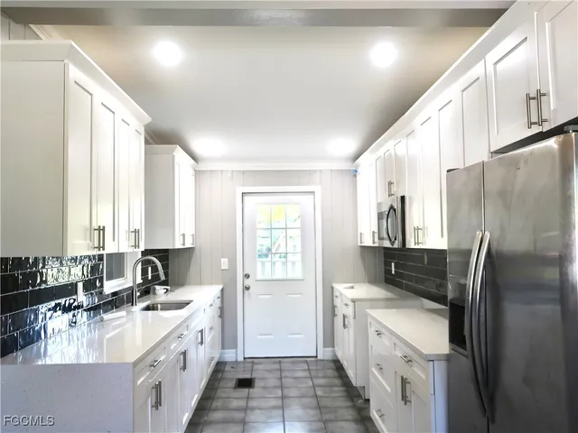 a kitchen with a sink stove and refrigerator