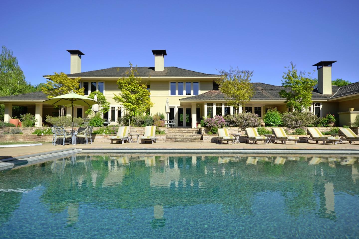 a swimming pool view with a outdoor seating