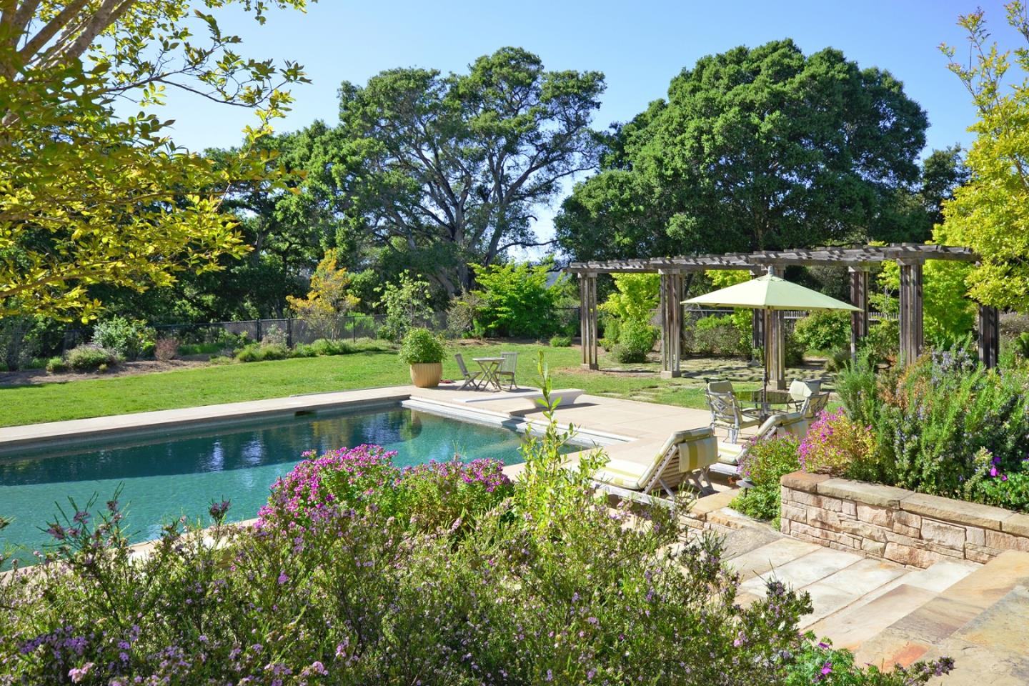 120 Edenvale Road Watsonville, CA 95076 - Photo 24 of 41 a view of a garden with a bench in the garden