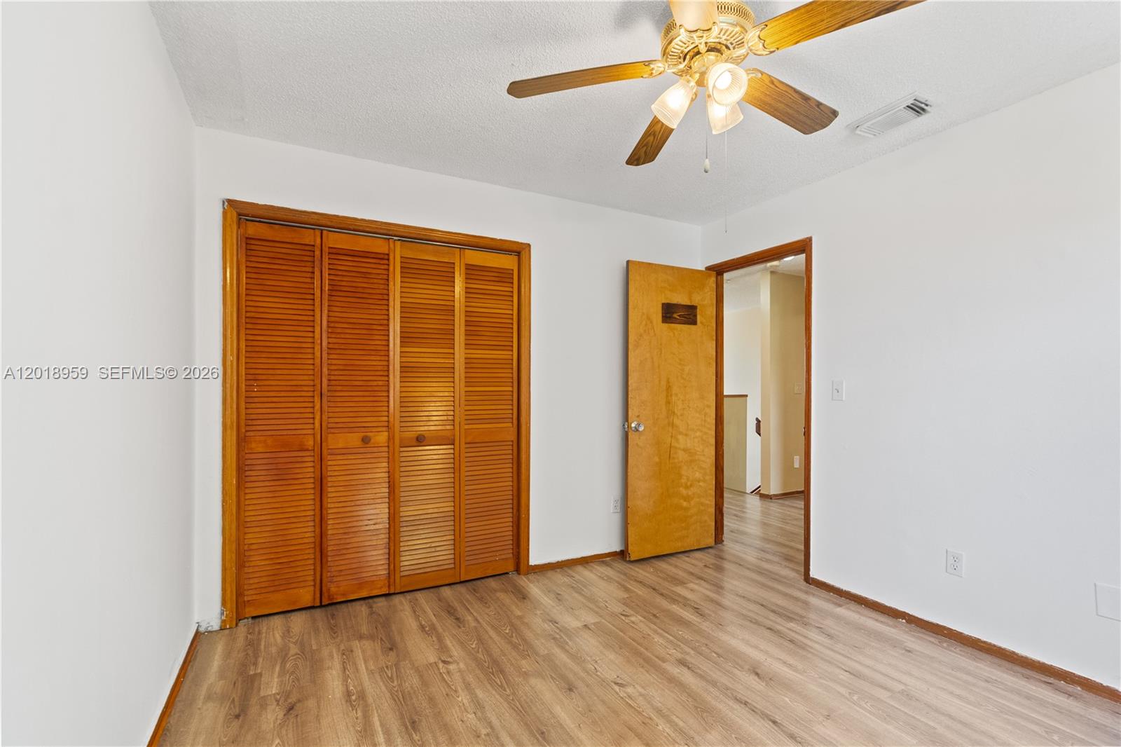 15345 Southwest 63rd Terrace Miami, FL 33193 - Photo 21 of 51 an empty room with wooden floor closet and windows