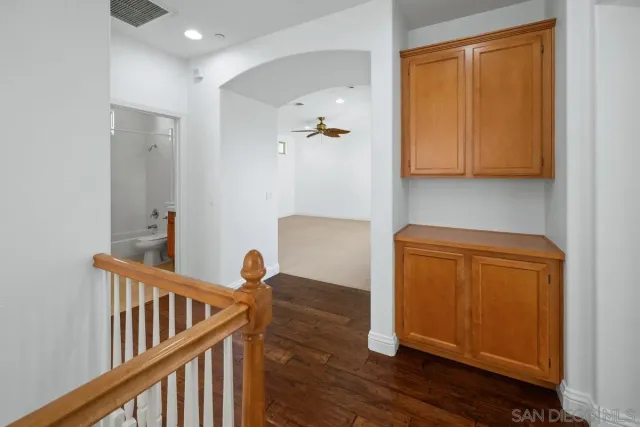 a view of hallway with wooden floor and stairs