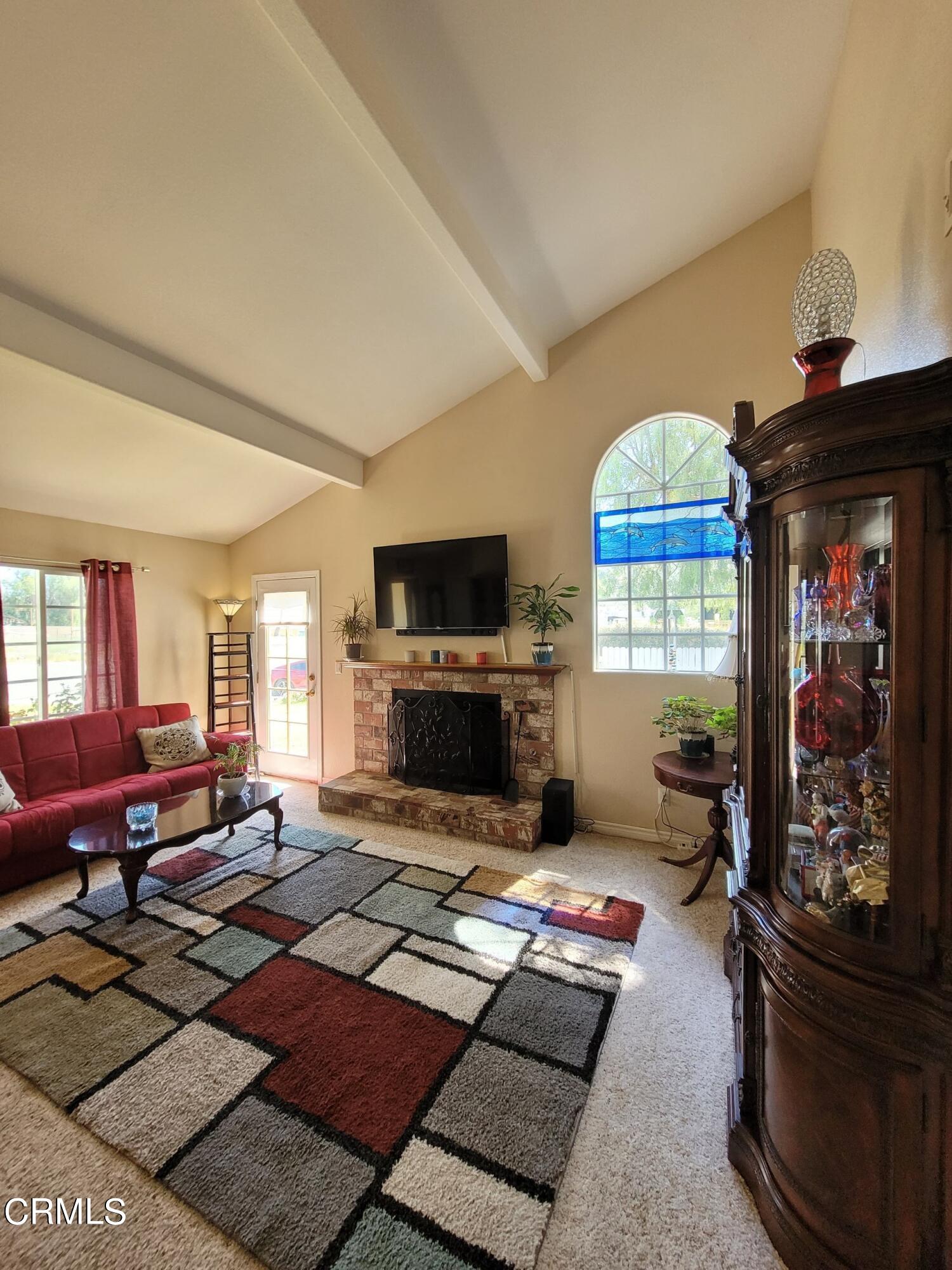 2059 Ralston Street Simi Valley, CA 93063 - Photo 11 of 34 a living room with furniture a fireplace and a flat screen tv