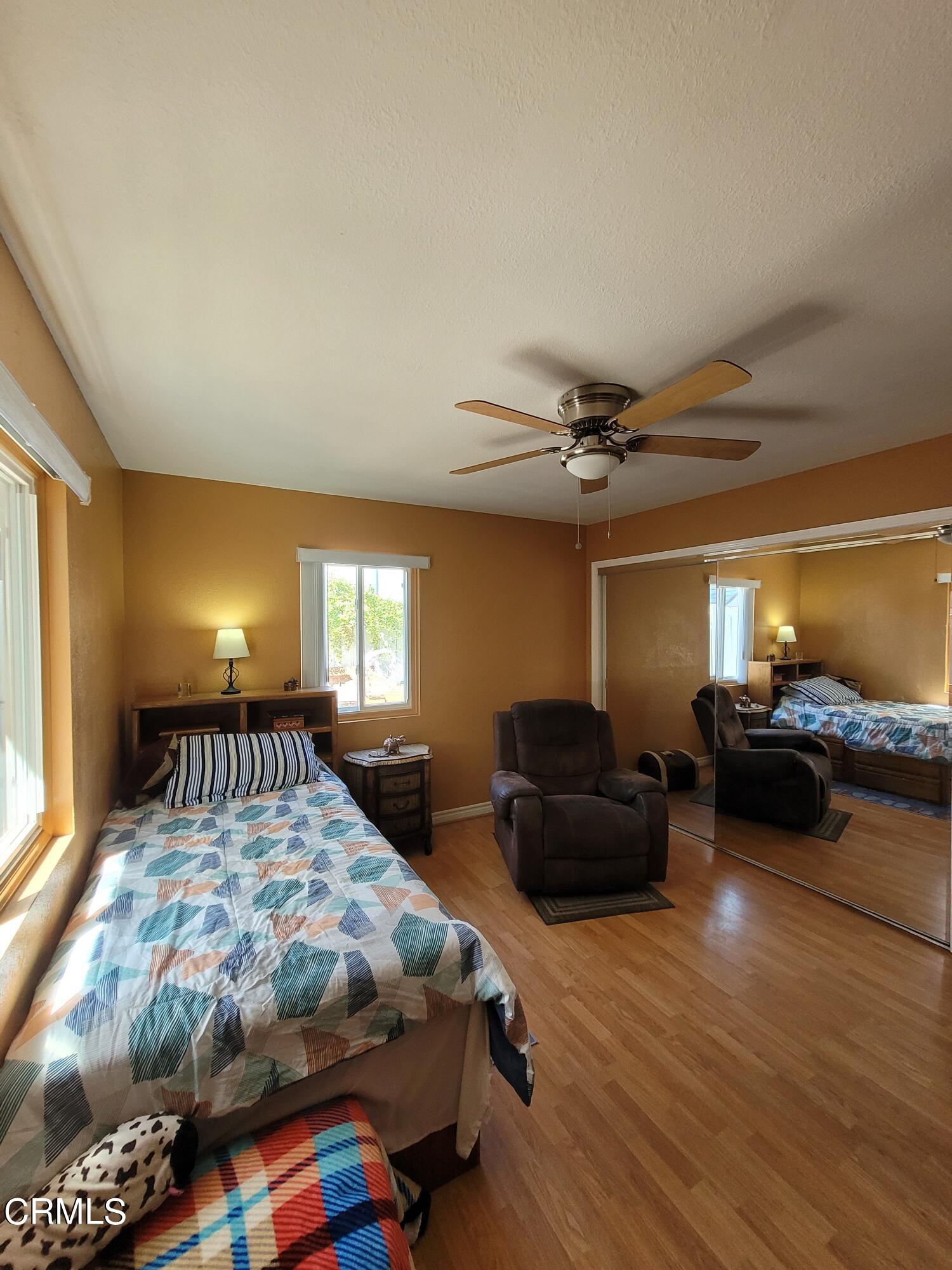 2059 Ralston Street Simi Valley, CA 93063 - Photo 27 of 34 a bedroom with a bed and wooden floor