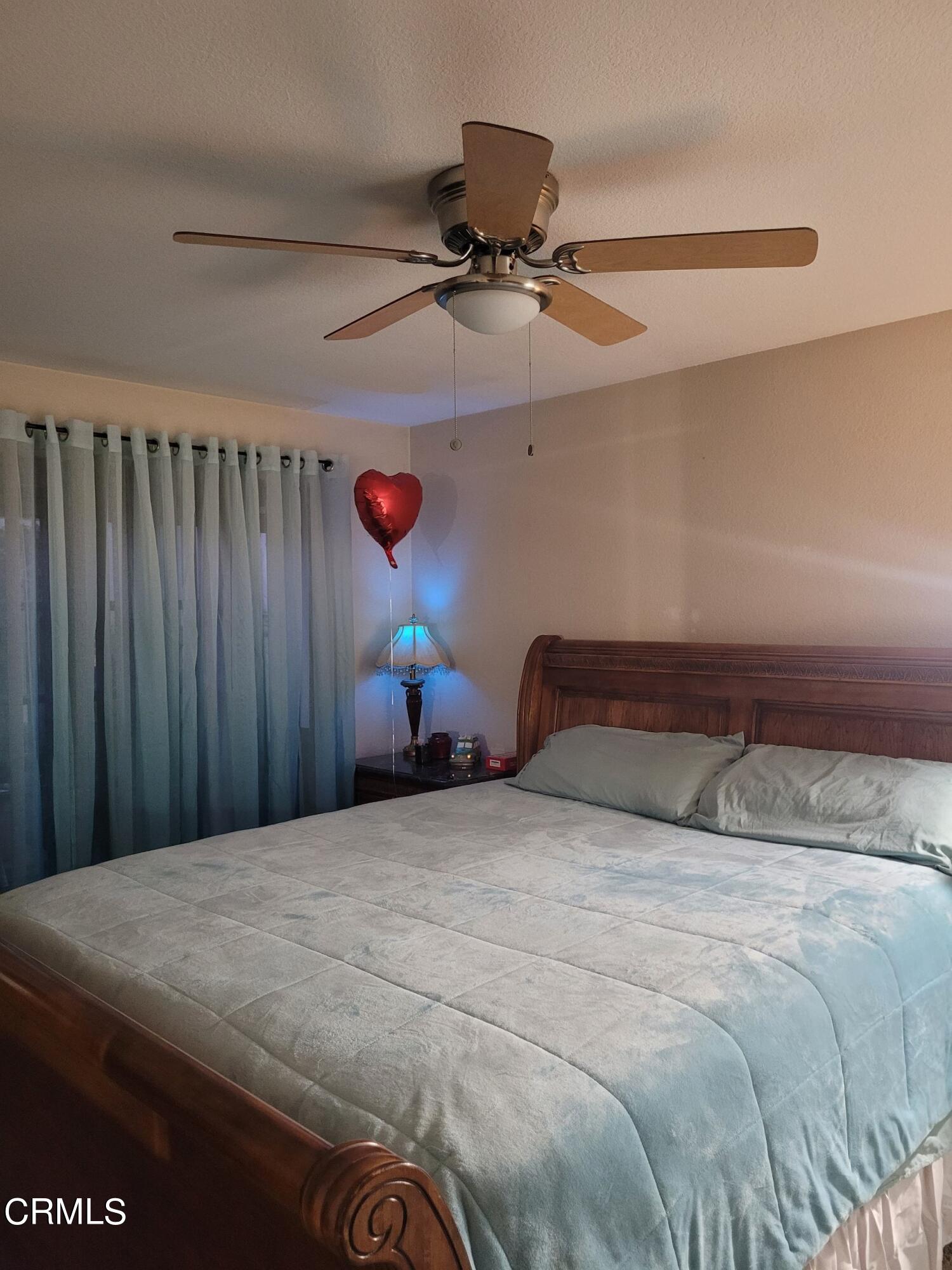 2059 Ralston Street Simi Valley, CA 93063 - Photo 31 of 34 a bedroom with a bed and a chandelier