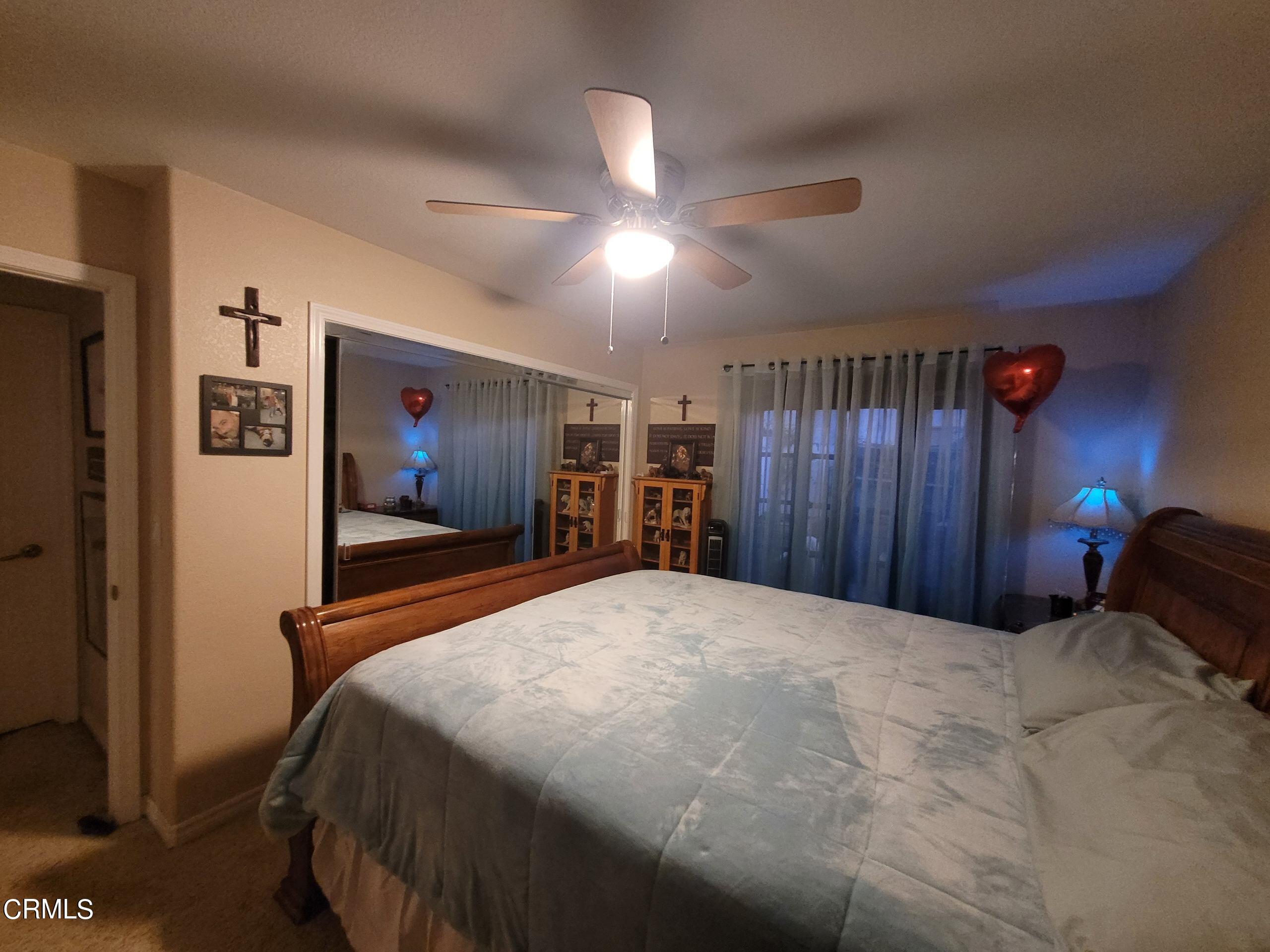 2059 Ralston Street Simi Valley, CA 93063 - Photo 32 of 34 a bedroom with a bed and a chandelier