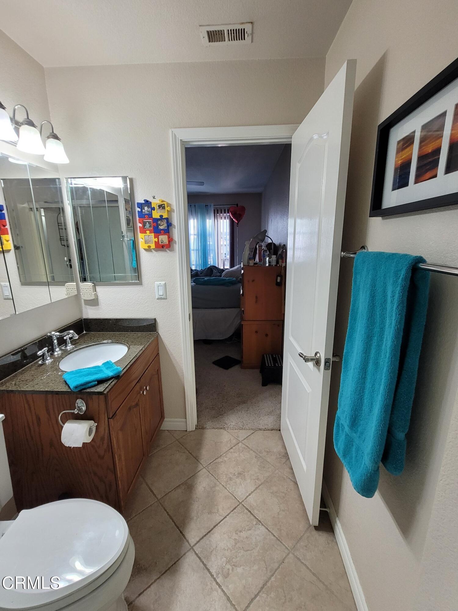 2059 Ralston Street Simi Valley, CA 93063 - Photo 34 of 34 a bathroom with a toilet sink and mirror