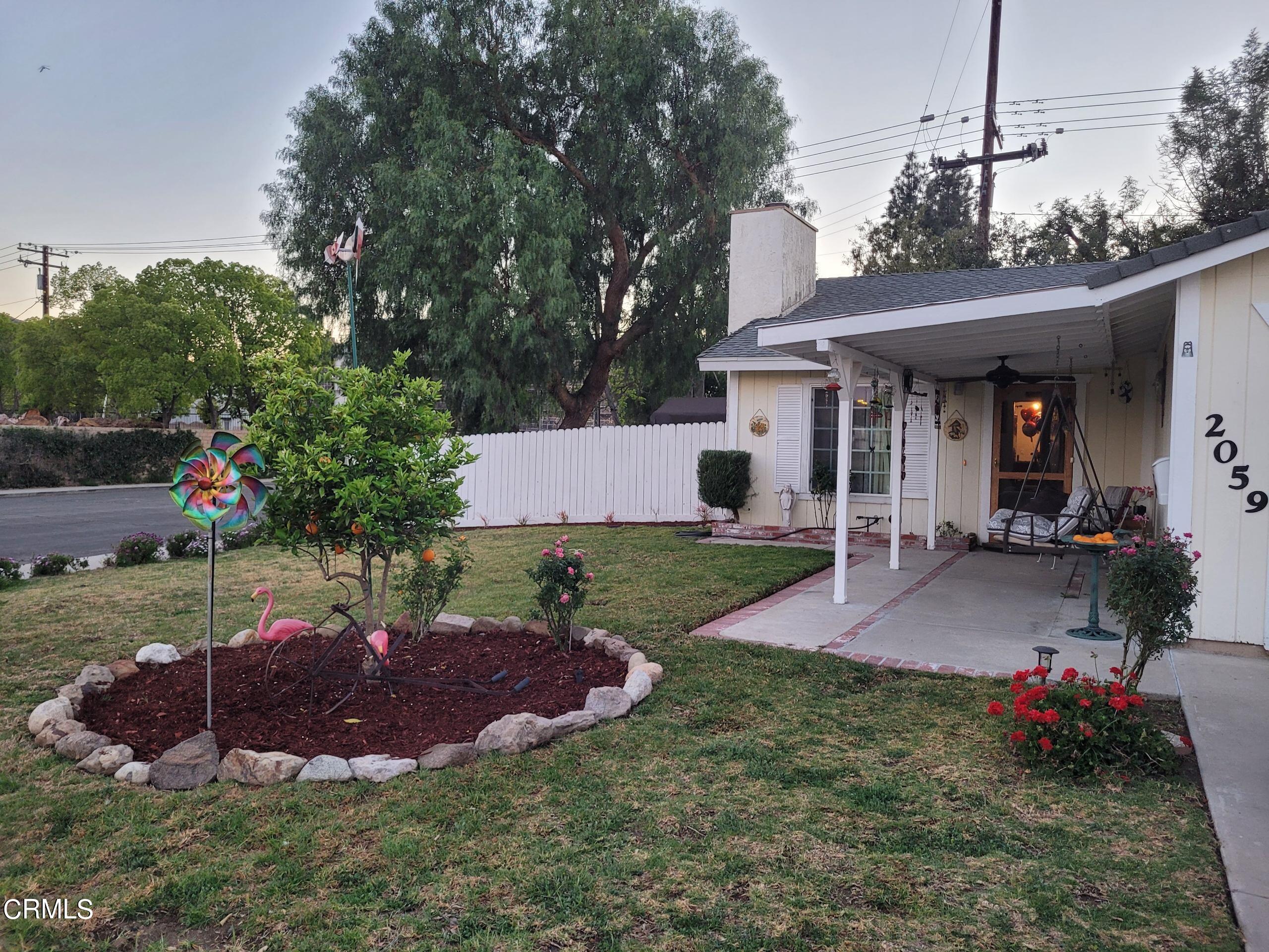 2059 Ralston Street Simi Valley, CA 93063 - Photo 6 of 34 a view of a house with a yard and garage