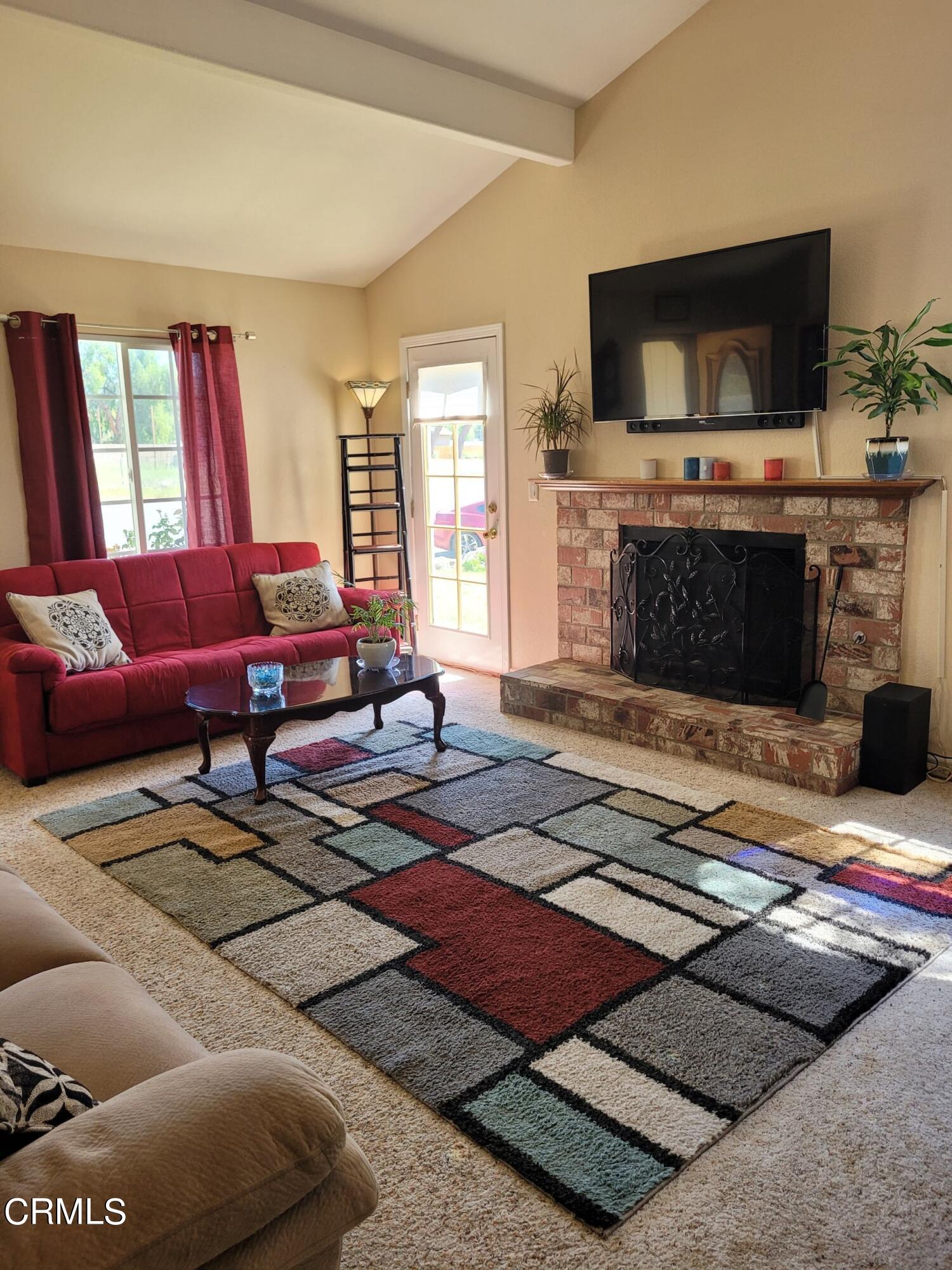 2059 Ralston Street Simi Valley, CA 93063 - Photo 10 of 34 a living room with furniture a flat screen tv and a fireplace
