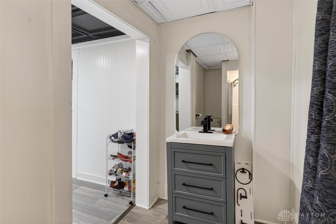 1726 Morgan Street Springfield, OH 45503 - Photo 16 of 30 This bright bathroom features a modern vanity and an arched mirror.