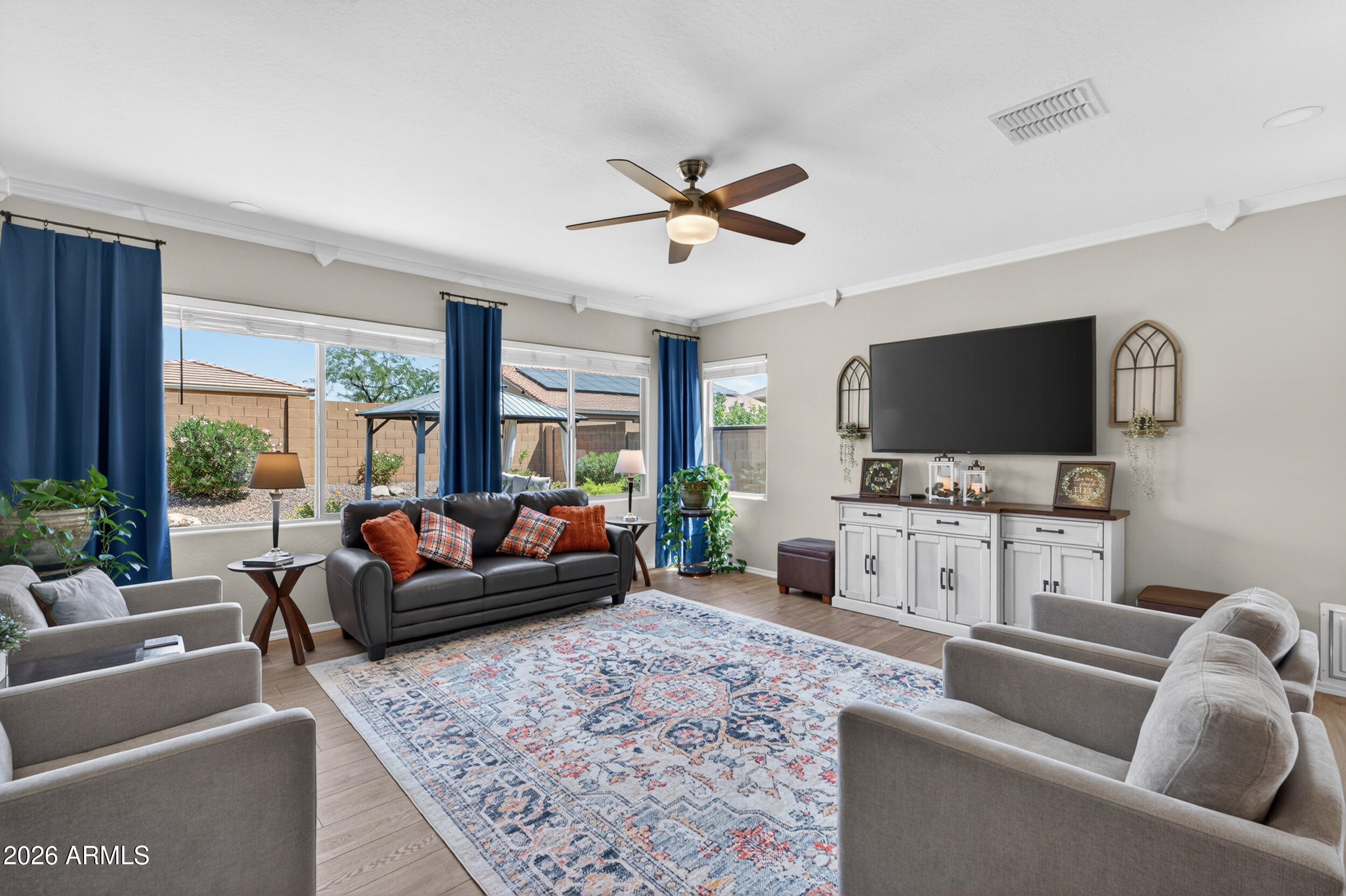 18612 West Mountain View Road Waddell, AZ 85355 - Photo 20 of 71 a living room with furniture and a flat screen tv