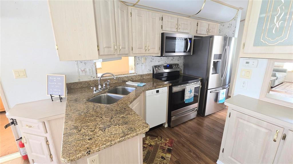 1317 Trout Punta Gorda, FL 33950 - Photo 12 of 55 a kitchen with stainless steel appliances granite countertop a sink stove and refrigerator