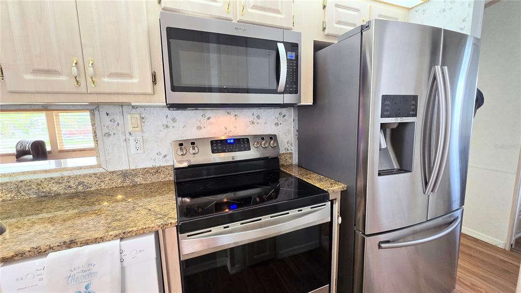 1317 Trout Punta Gorda, FL 33950 - Photo 15 of 55 a kitchen with granite countertop a refrigerator stove and microwave