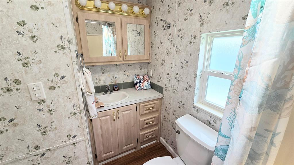 1317 Trout Punta Gorda, FL 33950 - Photo 21 of 55 view of a bathroom with a sink a toilet and a shower curtain