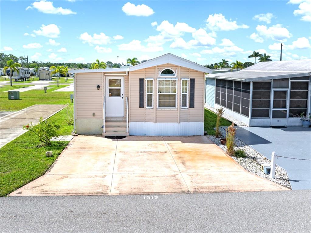 1317 Trout Punta Gorda, FL 33950 - Photo 46 of 55 a front view of a house with a garden and plants