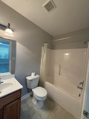 a white toilet sitting next to a bath tub