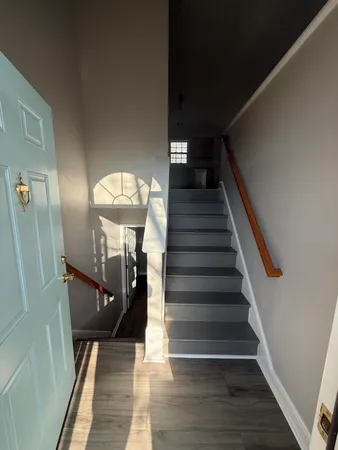 a view of entryway and hall with wooden floor