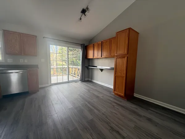 a view of empty room with wooden floor and fireplace