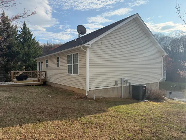 a view of a yard with wooden fence