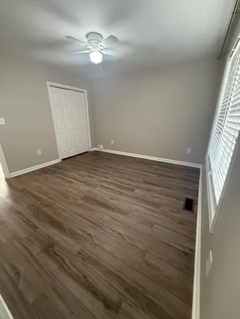 wooden floor in an empty room with a window