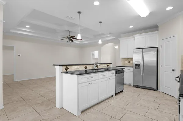 a kitchen with stainless steel appliances a refrigerator sink and stove