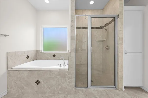 a bathroom with a tub a sink and a shower