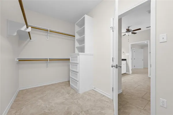 a kitchen with white cabinets and white appliances