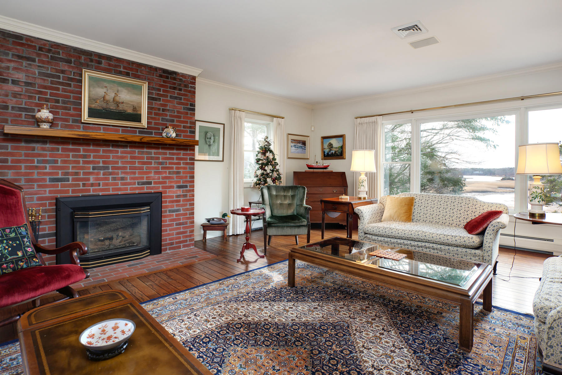 1855 South County Road Osterville, MA 02655 - Photo 9 of 26 a living room with furniture and a fireplace