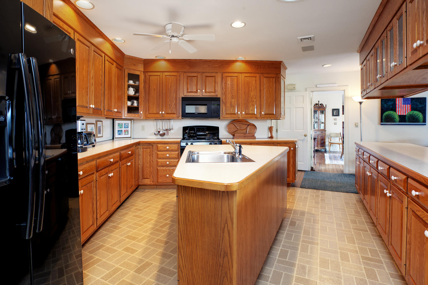 1855 South County Road Osterville, MA 02655 - Photo 10 of 26 a large kitchen with stainless steel appliances kitchen island a large counter top a sink and a refrigerator