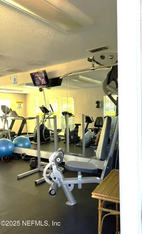 a view of a swimming pool with a table and chair under an umbrella