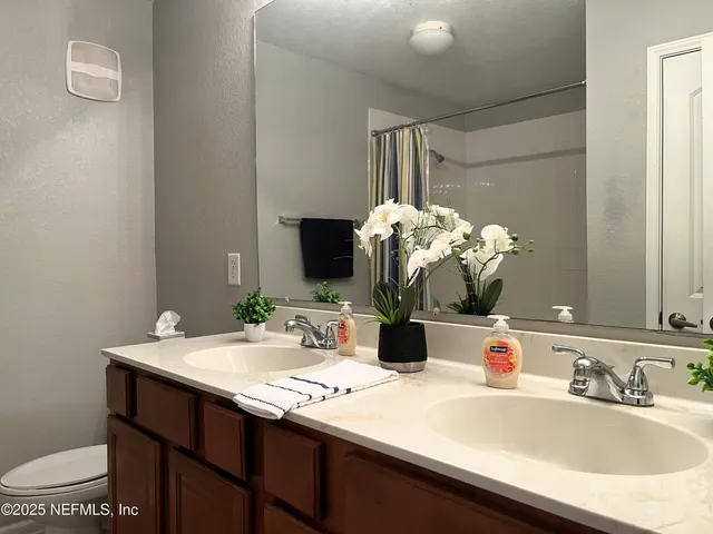 a bathroom with a sink vanity and a mirror