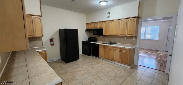 a kitchen with a sink and a refrigerator